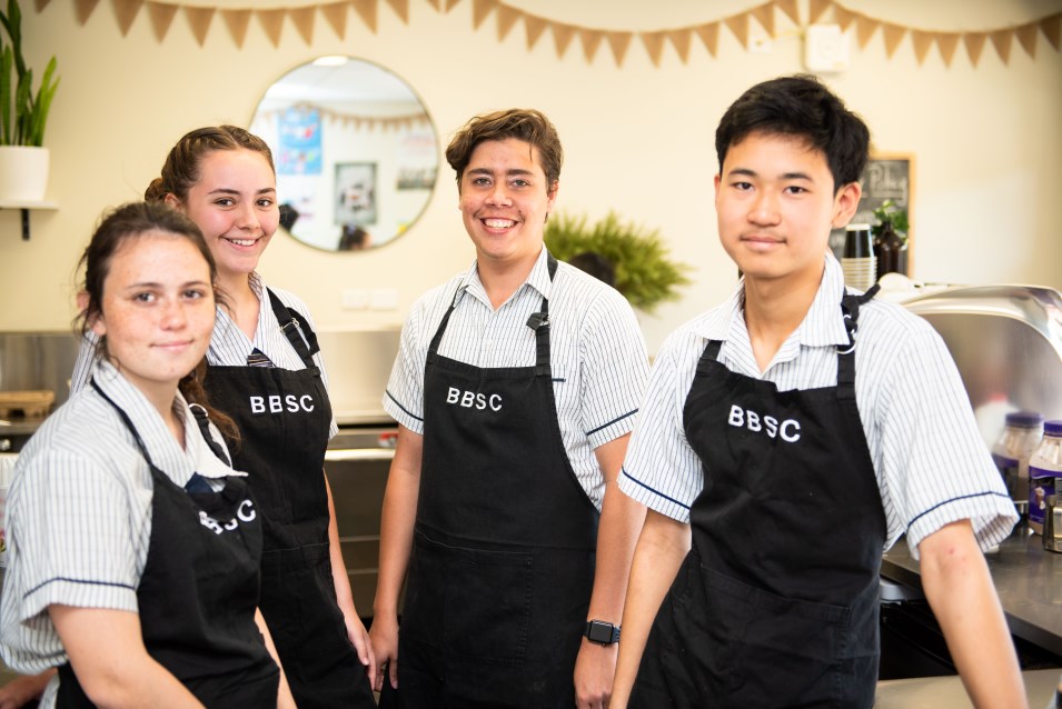 Students in aprons in canteen.